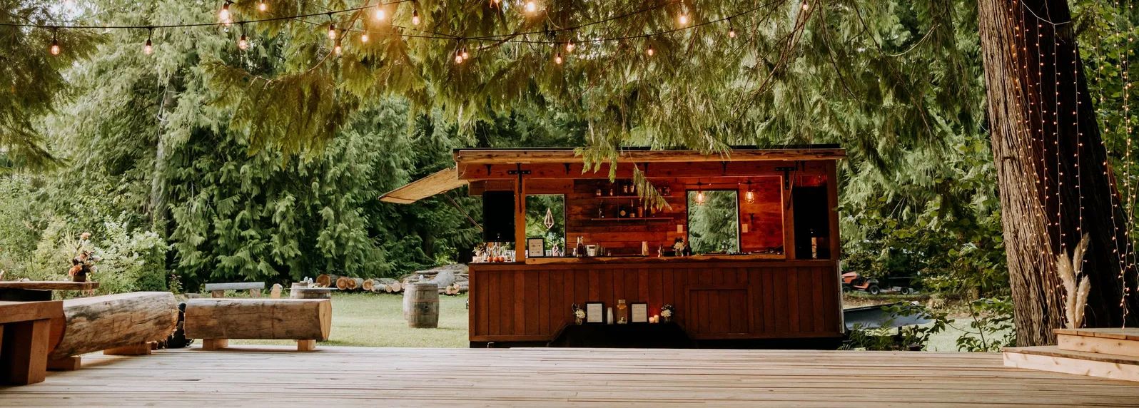 The Boombox trailer under cedars and string lights