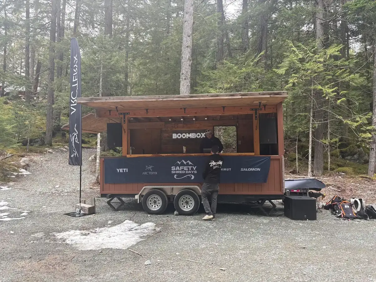 Whistler Boombox mobile DJ bar with an Arc'teryx feather flag at Safety Shred Days