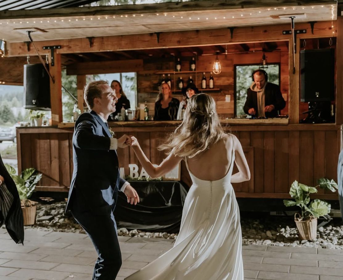 A couple dancing in front of the Boombox while DJ Huck plays